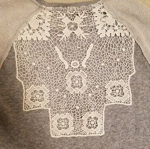 Grey sweater with lace detail.